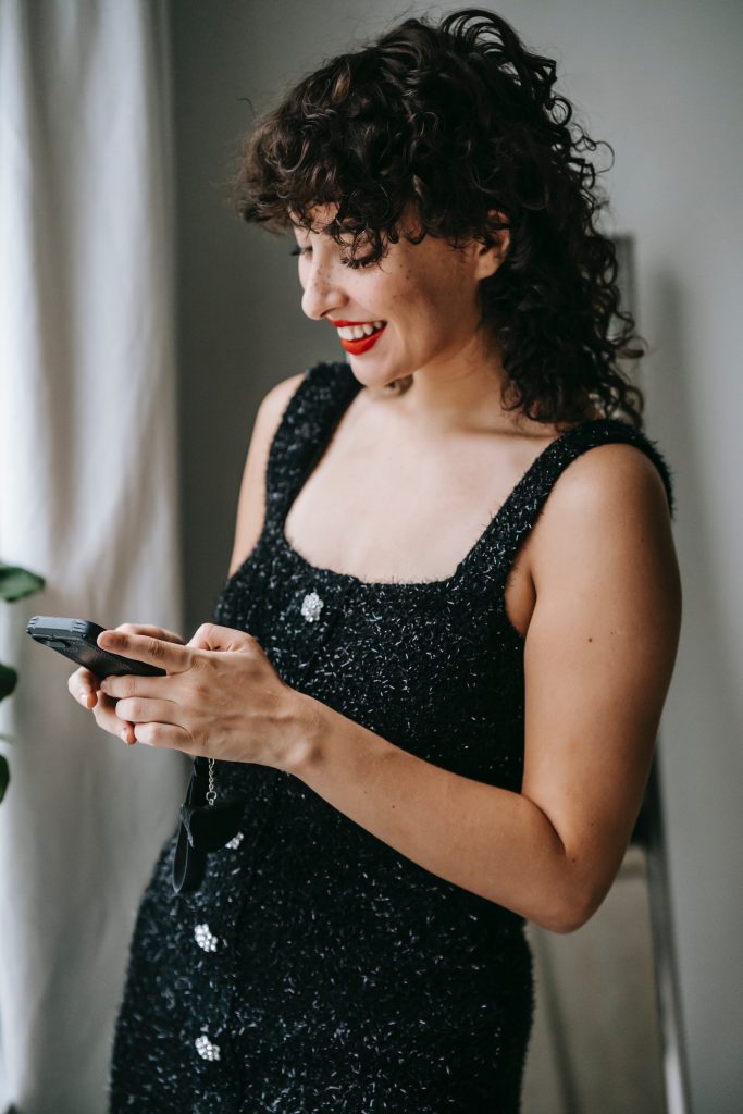 woman looking at her phone with flirty text
