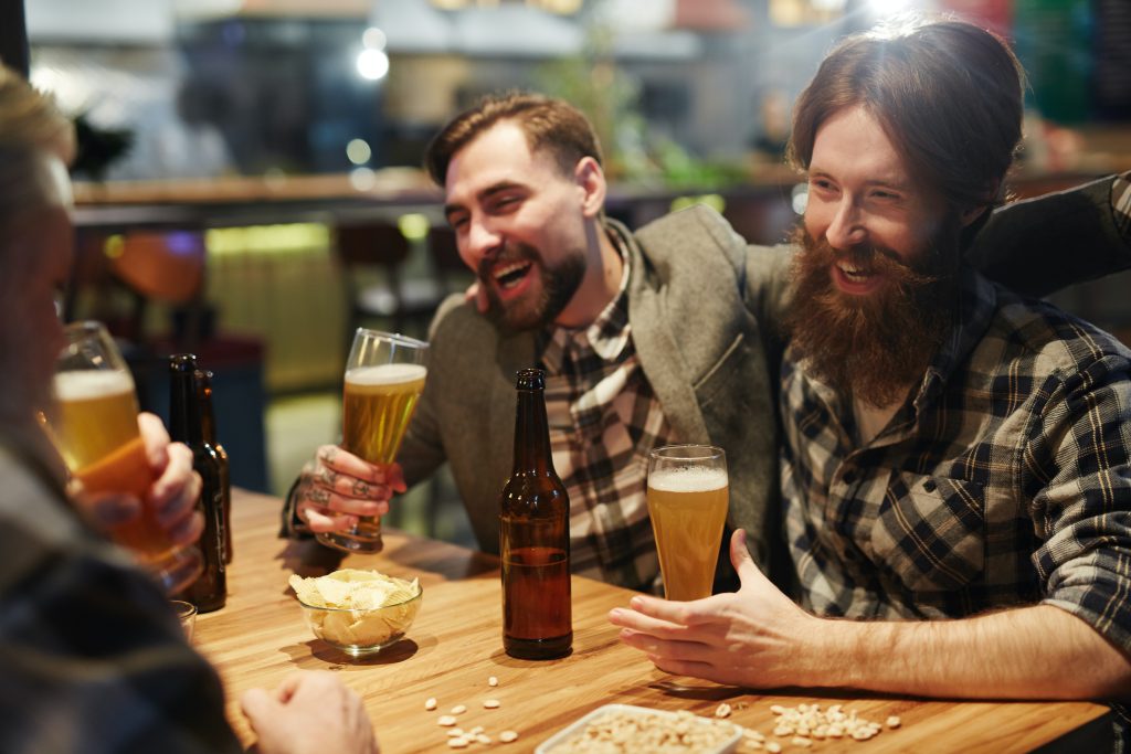 group of men drinking beer laughing